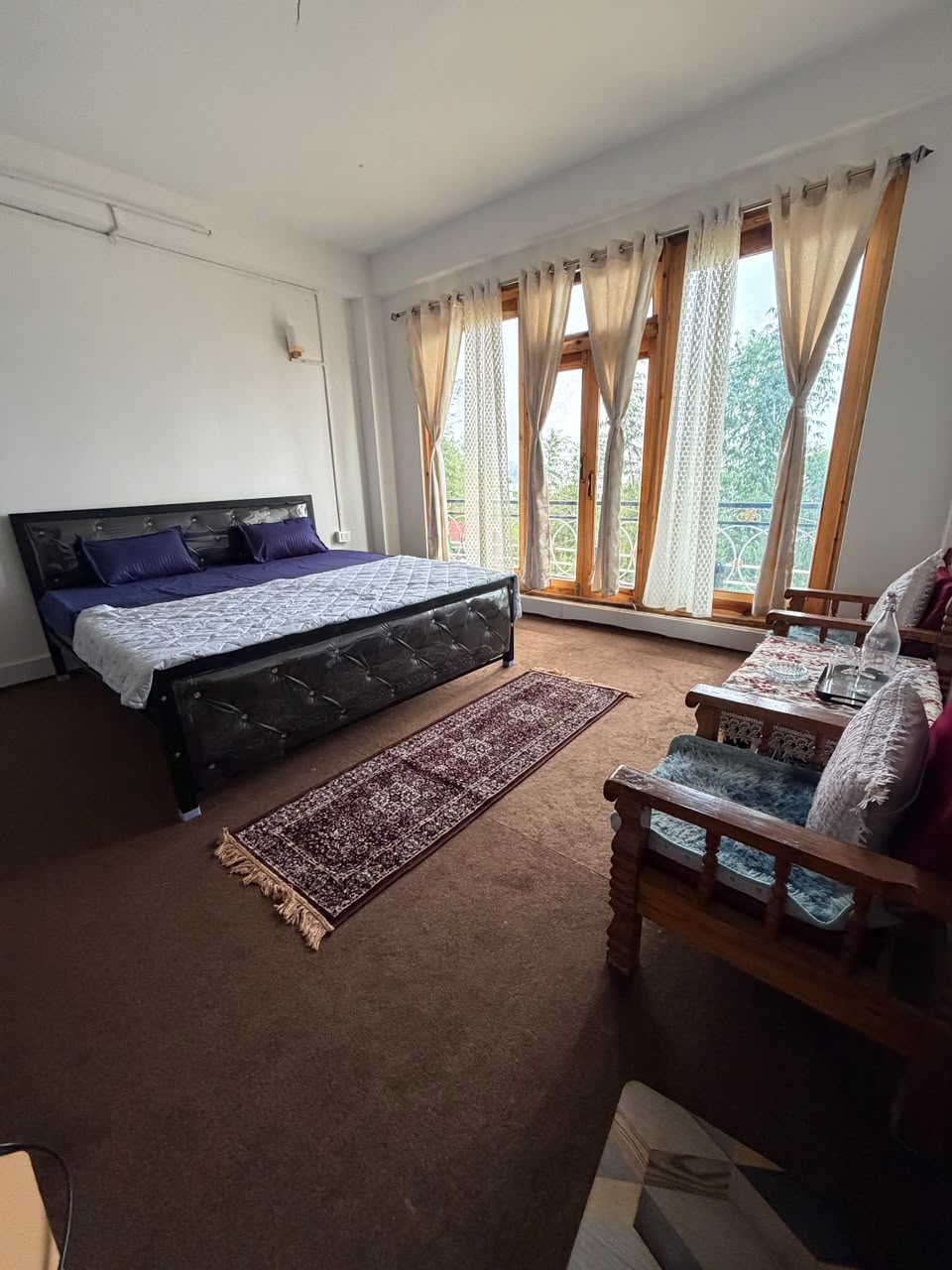 Spacious double room with balcony and seating area at Kepchaki Stay