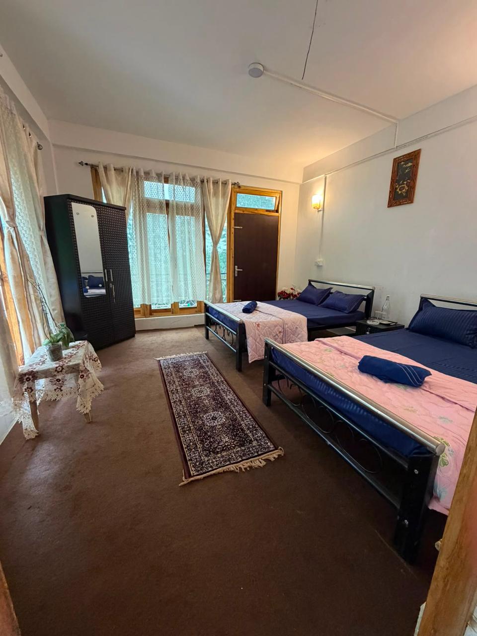 Double bedroom with garden-facing windows at Kepchaki Stay